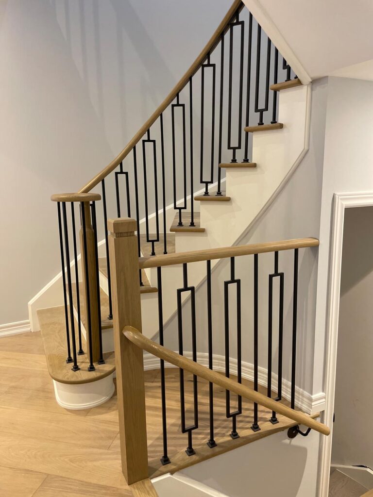 Staircase refinishing with metal pickets and new vinyl flooring